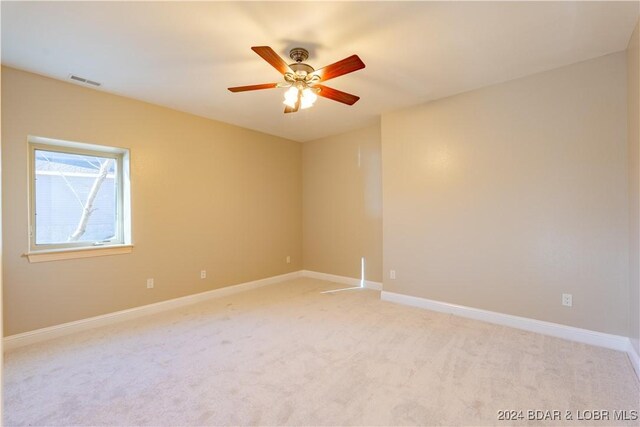 unfurnished room featuring light carpet and ceiling fan