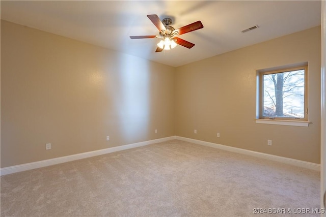 empty room with light carpet and ceiling fan