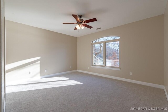 carpeted empty room with ceiling fan