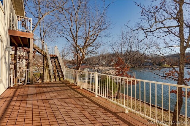 wooden terrace featuring a water view