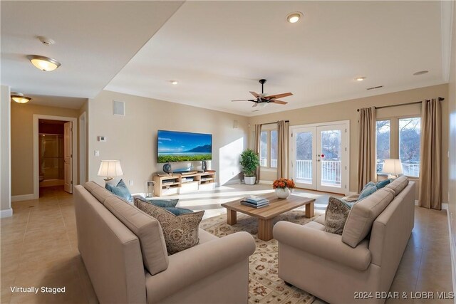 tiled living room featuring french doors and ceiling fan