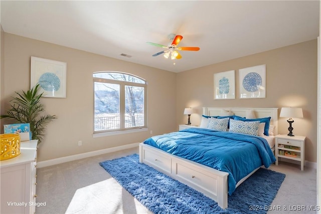 bedroom with ceiling fan and light colored carpet