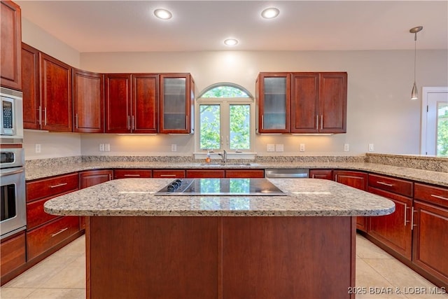 550 Grand Cove Rd, Porto Cima, MO 65079 - kitchen with appliances with stainless steel finishes, light tile patterned flooring, a center island, dark brown cabinets, and hanging light fixtures