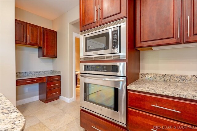 550 Grand Cove Rd, Porto Cima, MO 65079 - kitchen with appliances with stainless steel finishes, dark brown cabinets, and light stone countertops