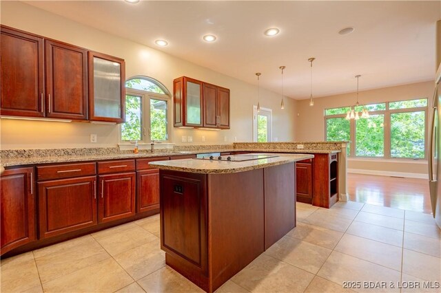 550 Grand Cove Rd, Porto Cima, MO 65079 - kitchen with plenty of natural light, a kitchen island, light tile patterned floors, black electric cooktop, and recessed lighting