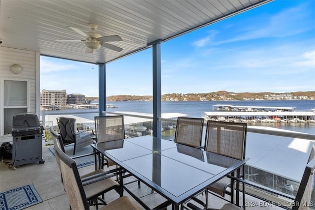 view of patio featuring ceiling fan, a water view, a balcony, and grilling area