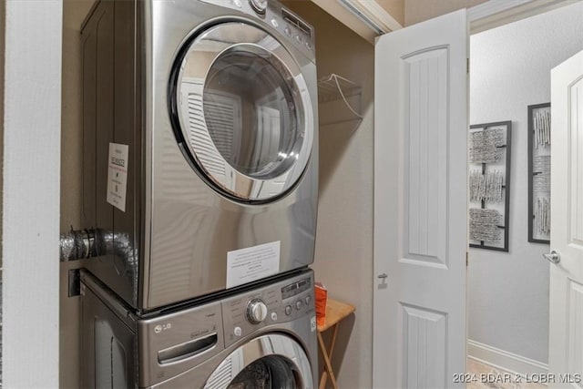 laundry room with stacked washer / drying machine