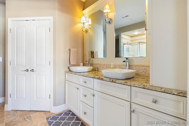 bathroom featuring vanity and an enclosed shower