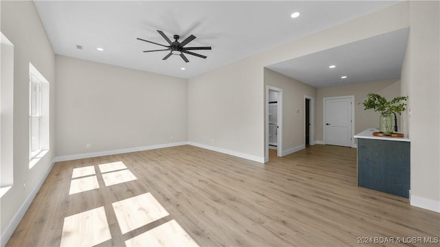 unfurnished room with ceiling fan and light hardwood / wood-style flooring