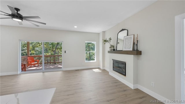 unfurnished living room featuring ceiling fan and light hardwood / wood-style flooring