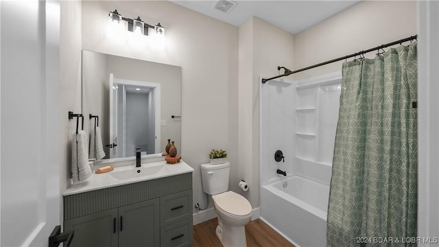 full bathroom with shower / bath combo with shower curtain, hardwood / wood-style floors, vanity, and toilet