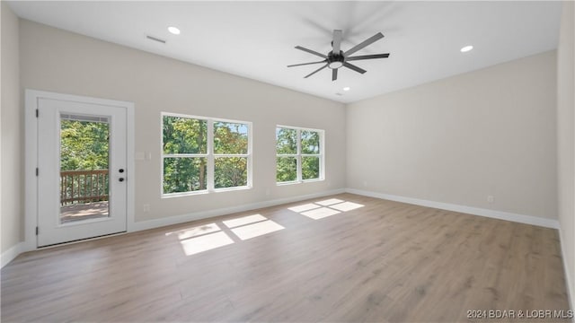 spare room with light hardwood / wood-style flooring and ceiling fan