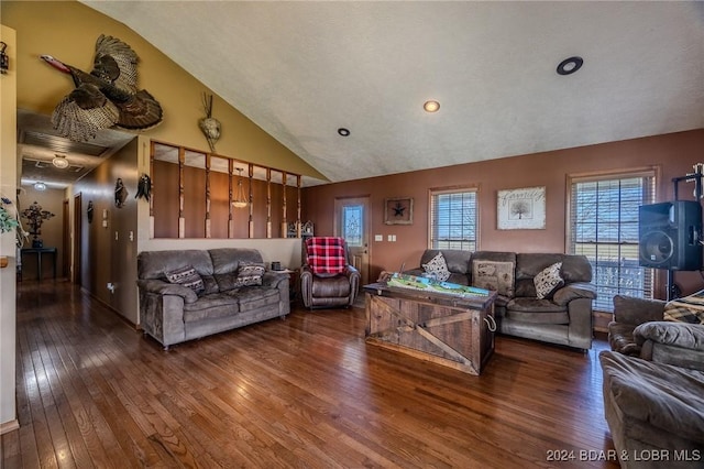 living room featuring a textured ceiling, hardwood / wood-style flooring, and high vaulted ceiling