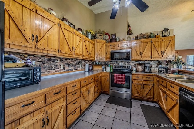 kitchen with a textured ceiling, decorative backsplash, light tile patterned flooring, and stainless steel appliances