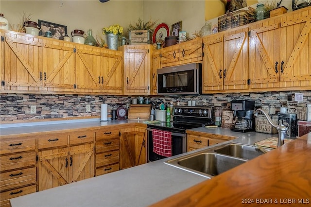 kitchen featuring backsplash, electric range, and sink