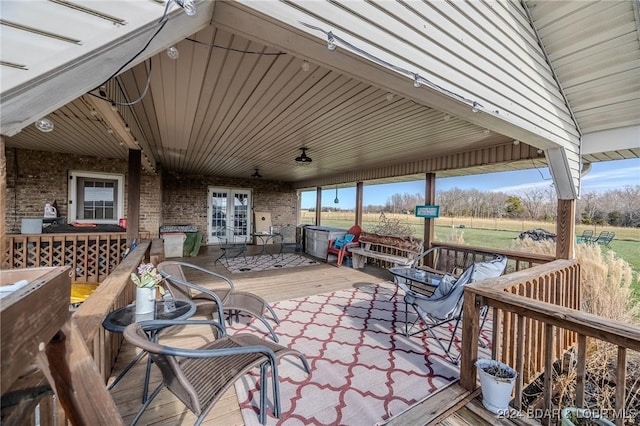 view of patio with french doors, a rural view, and a deck