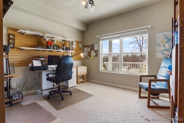 carpeted office space featuring ceiling fan