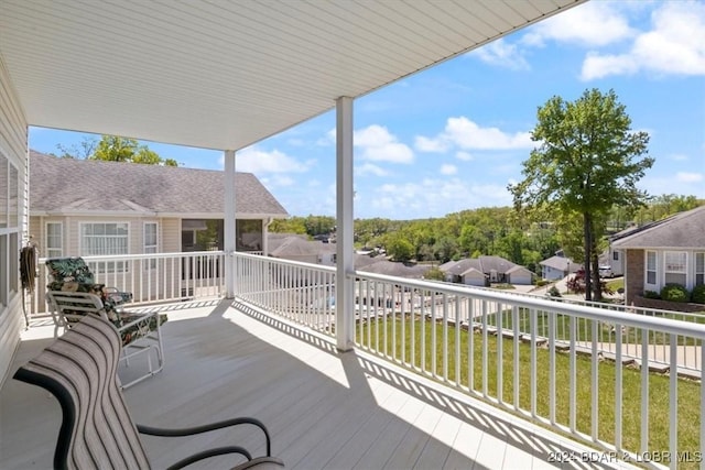 wooden deck featuring a lawn