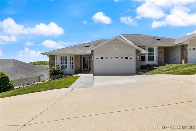 ranch-style home with a front lawn and a garage