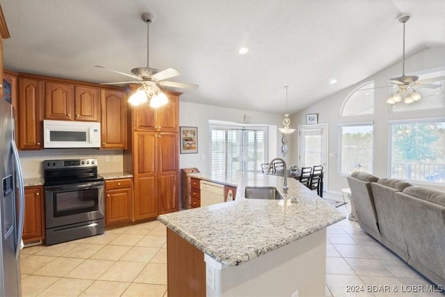 kitchen with lofted ceiling, sink, hanging light fixtures, an island with sink, and stainless steel appliances