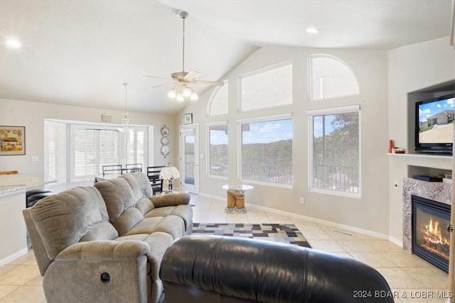 tiled living room featuring ceiling fan and lofted ceiling