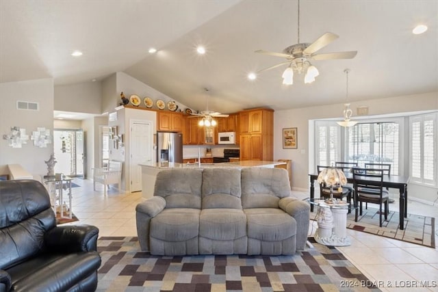 tiled living room featuring ceiling fan, a healthy amount of sunlight, and high vaulted ceiling