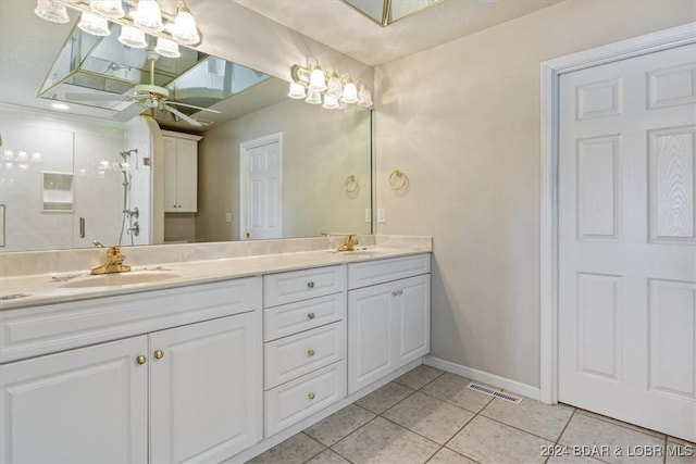 bathroom with tile patterned flooring, vanity, and a shower with shower door