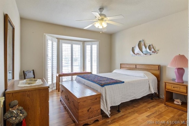 bedroom with hardwood / wood-style floors and ceiling fan