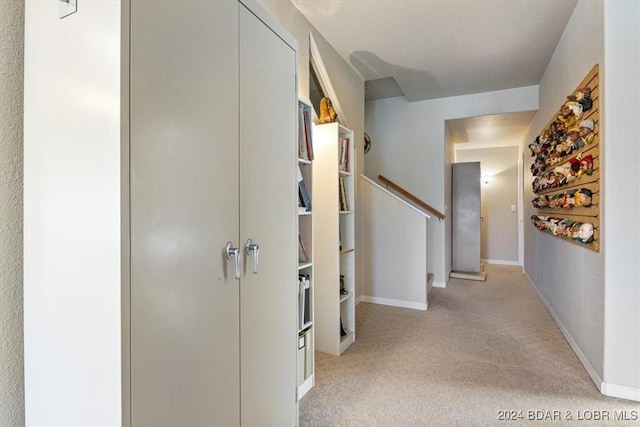 hallway featuring light colored carpet