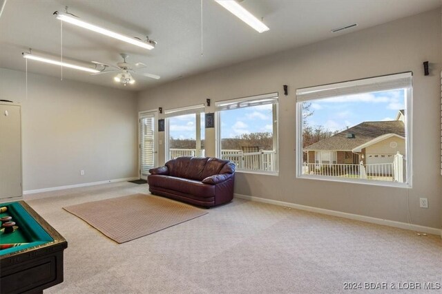 interior space with carpet and ceiling fan