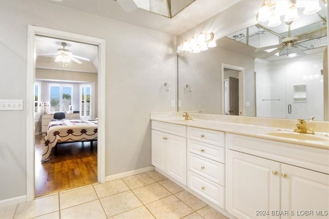 bathroom with tile patterned flooring, vanity, ceiling fan, and a shower with shower door