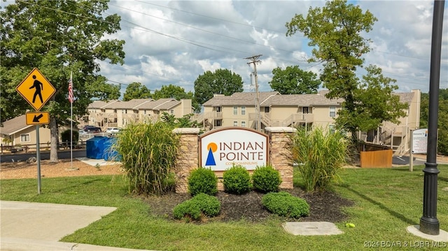 community sign featuring a lawn