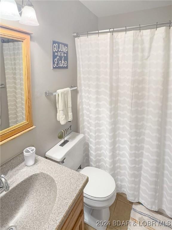 bathroom featuring tile patterned floors, vanity, and toilet