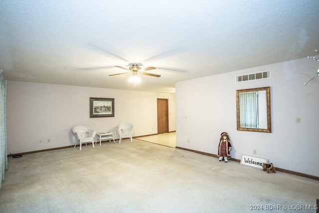 carpeted spare room with ceiling fan and a textured ceiling