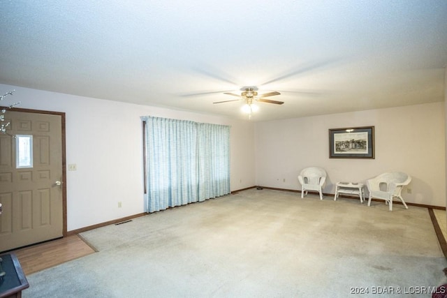 interior space featuring ceiling fan and carpet flooring