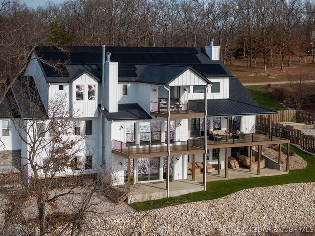 rear view of house featuring a patio area and a balcony