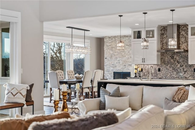 living room with a stone fireplace and sink