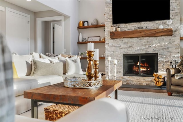 living room with hardwood / wood-style flooring and a fireplace