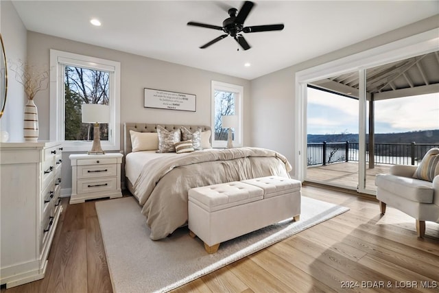 bedroom with access to exterior, light hardwood / wood-style floors, multiple windows, and ceiling fan