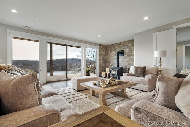 living room with light wood-type flooring and a wood stove