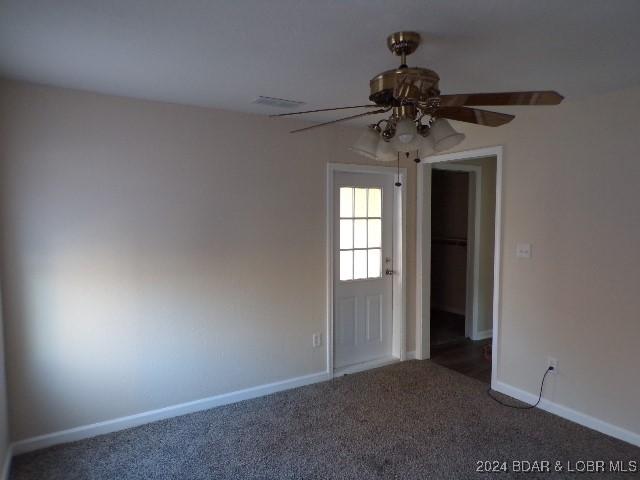 unfurnished room with carpet and ceiling fan