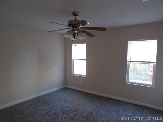 empty room with ceiling fan and carpet floors