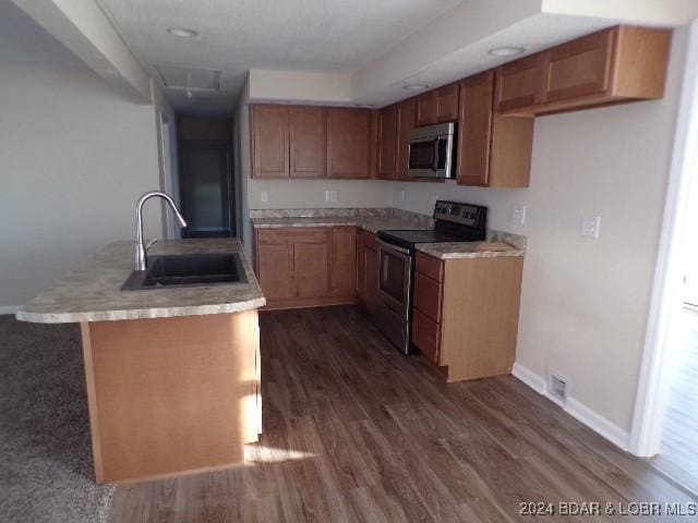 kitchen featuring dark hardwood / wood-style floors, black range with electric stovetop, and sink