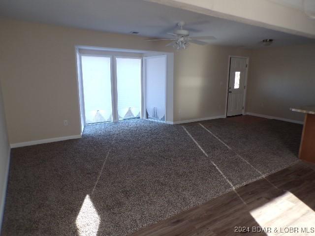 empty room featuring dark hardwood / wood-style flooring and ceiling fan