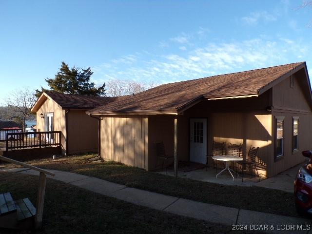 rear view of house featuring a deck and a patio area