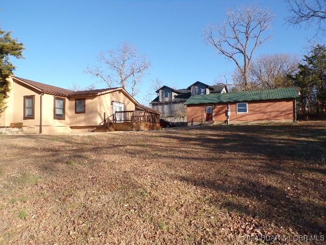 rear view of house featuring a yard