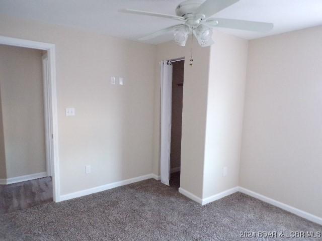 unfurnished bedroom with ceiling fan and carpet floors