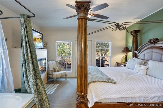 bedroom with multiple windows, ceiling fan, and carpet