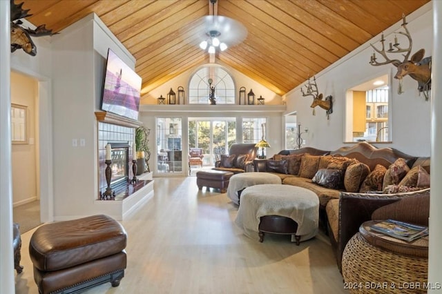 6334 Red Barn Rd, Osage Beach, MO 65065 - living area featuring wooden ceiling, a tiled fireplace, wood finished floors, and high vaulted ceiling
