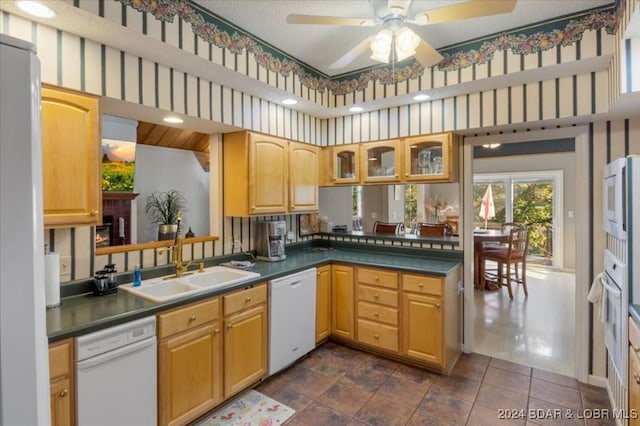 6334 Red Barn Rd, Osage Beach, MO 65065 - kitchen featuring white appliances, ceiling fan, glass insert cabinets, dark countertops, and a peninsula